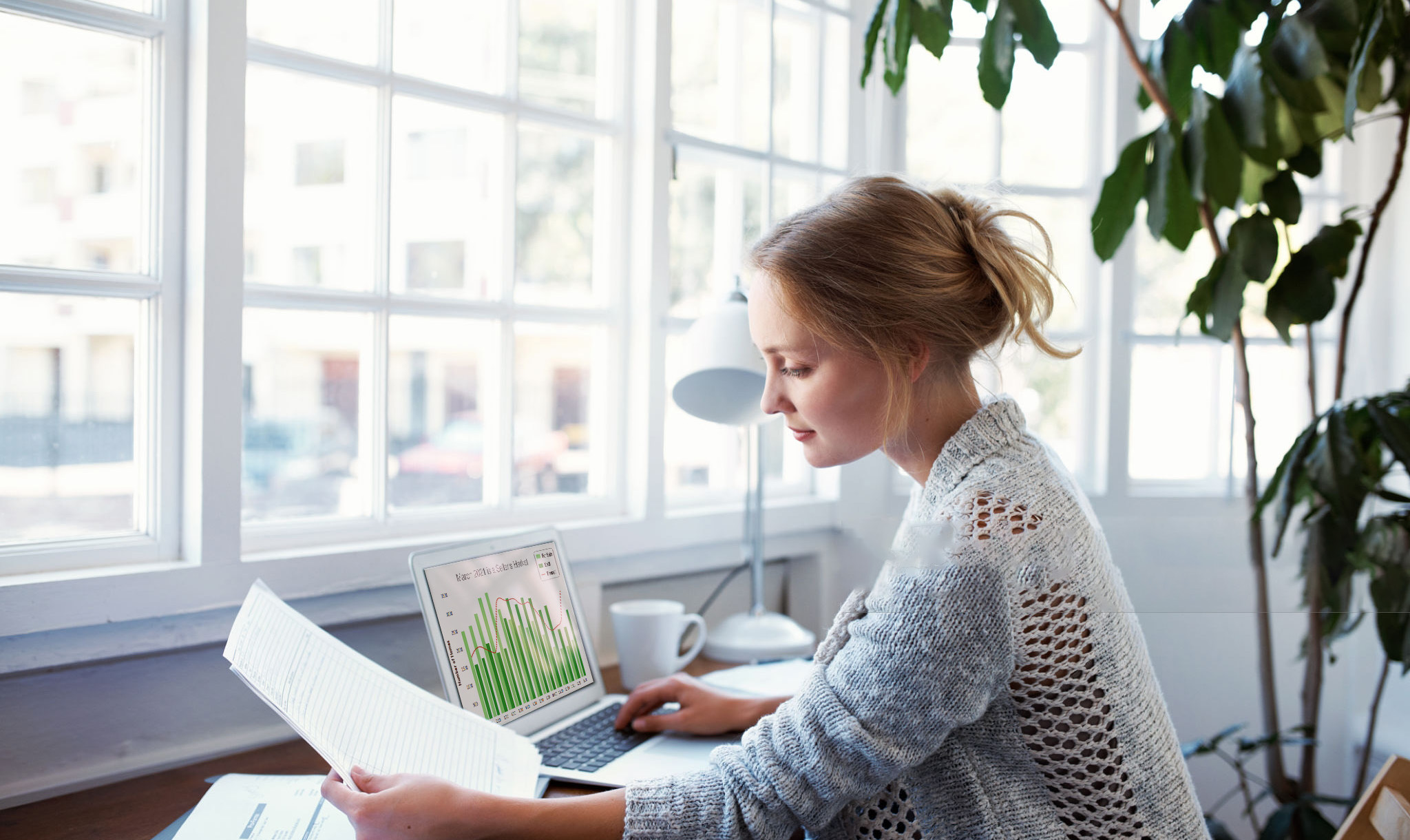 Woman on computer using TrendGraphix product