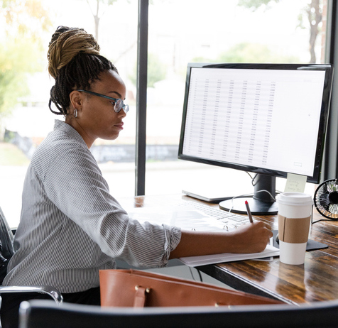 Woman at computer MLS Professional using TrendGraphix product