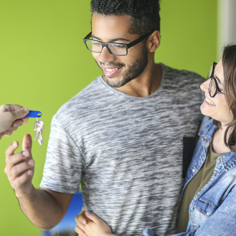 Couple receiving keys for home purchase