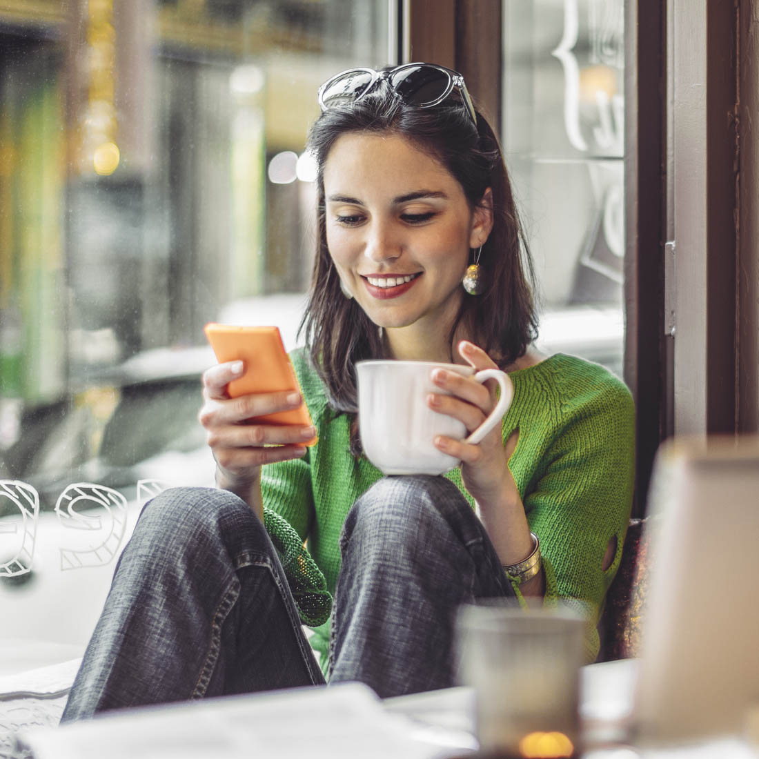 Woman in cafe on phone broker